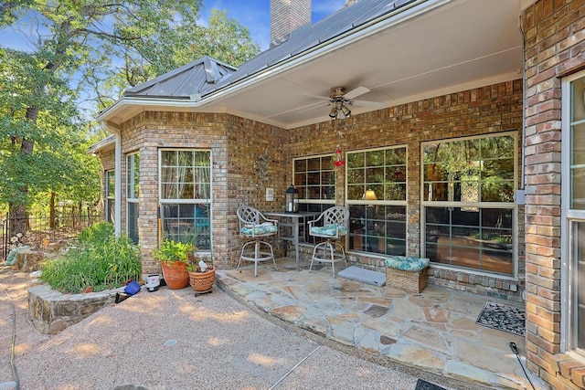 view of patio featuring ceiling fan and fence