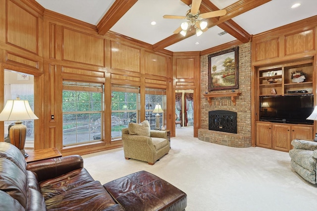 living area with built in shelves, wooden walls, light colored carpet, a brick fireplace, and beam ceiling