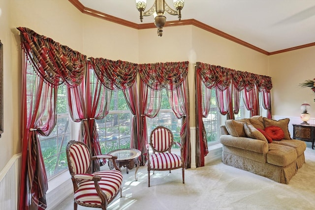 living area with plenty of natural light, carpet, a notable chandelier, and crown molding