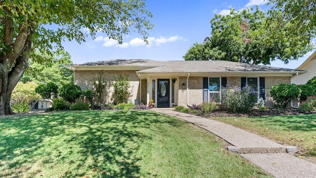 single story home with brick siding and a front lawn