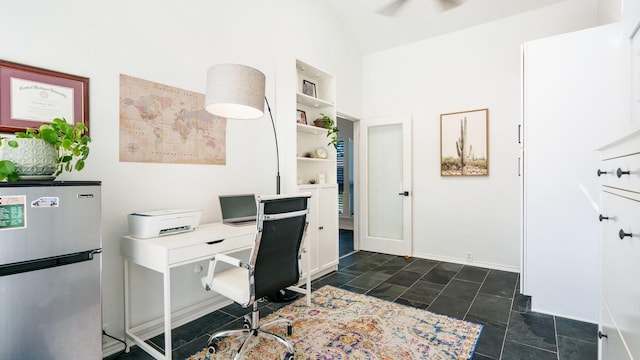 office space with a ceiling fan and vaulted ceiling