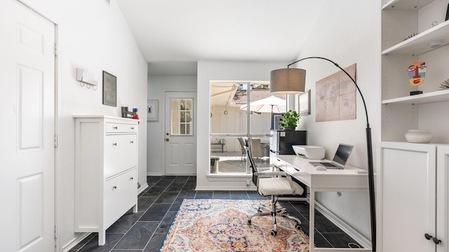 office area featuring dark tile patterned flooring