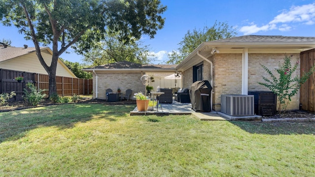 view of yard with central AC, a patio, and a fenced backyard