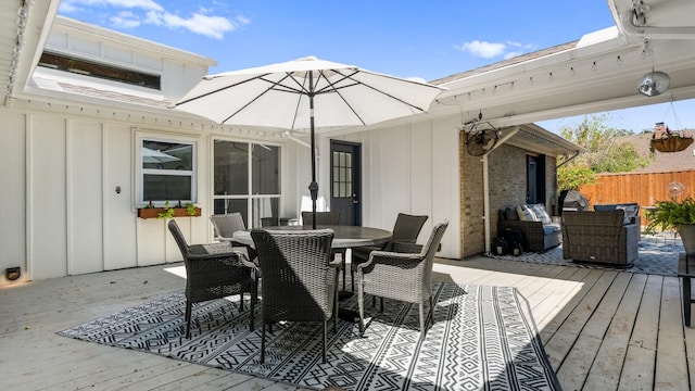 wooden deck featuring outdoor dining space and fence