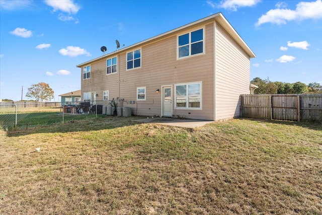 rear view of property featuring a patio, a lawn, cooling unit, and a fenced backyard