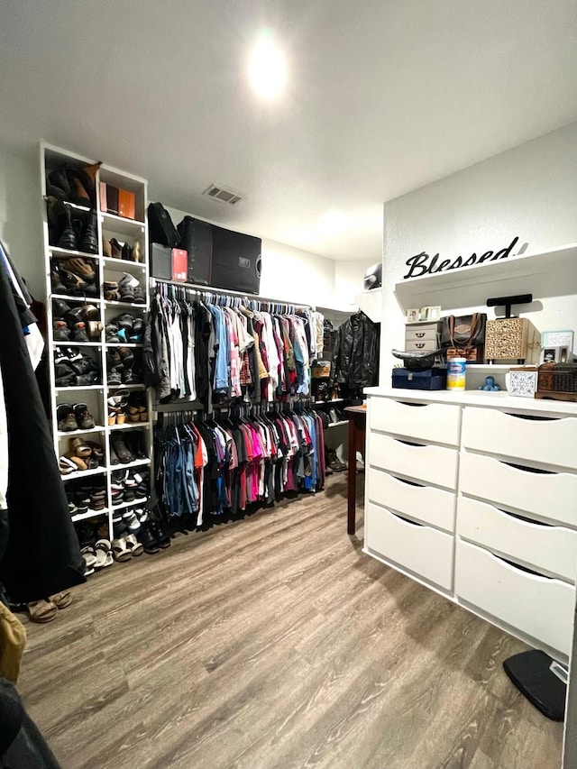 walk in closet featuring visible vents and wood finished floors