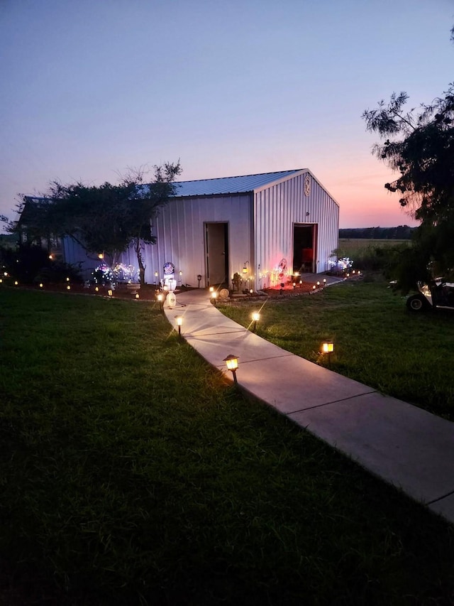 exterior space featuring board and batten siding and a lawn
