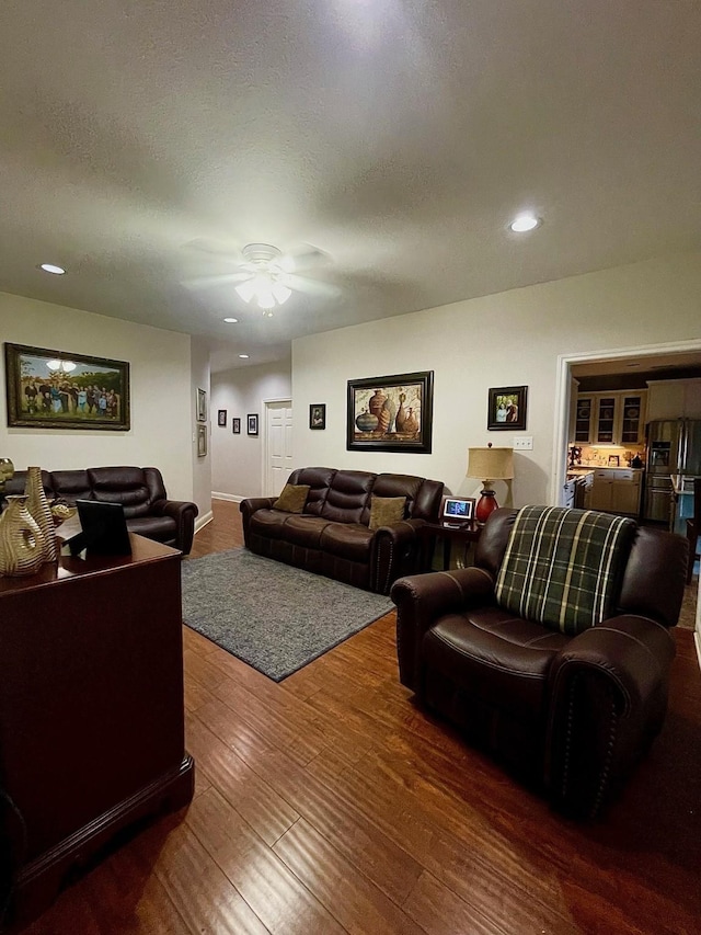 living area with a textured ceiling, ceiling fan, wood finished floors, and recessed lighting