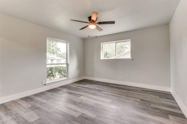 unfurnished room with ceiling fan, baseboards, and wood finished floors