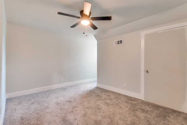 empty room with light colored carpet, visible vents, ceiling fan, and baseboards