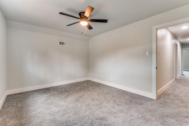 unfurnished room featuring a ceiling fan, light carpet, visible vents, and baseboards