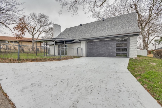 view of front of house with a front yard, brick siding, fence, and an attached garage