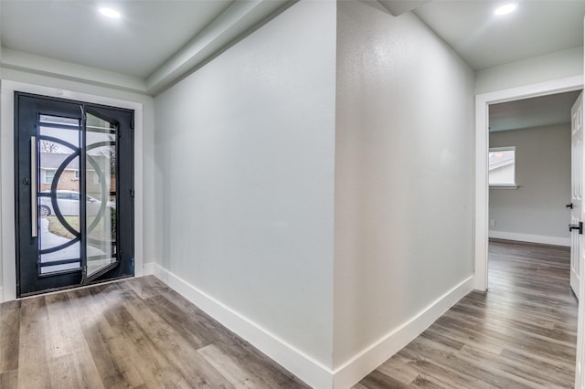 foyer entrance with recessed lighting, light wood-type flooring, and baseboards