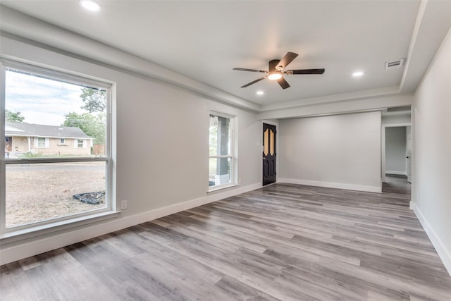 unfurnished room with recessed lighting, visible vents, light wood-style flooring, and baseboards