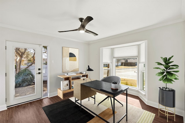 office space with dark wood-type flooring, ornamental molding, baseboards, and ceiling fan