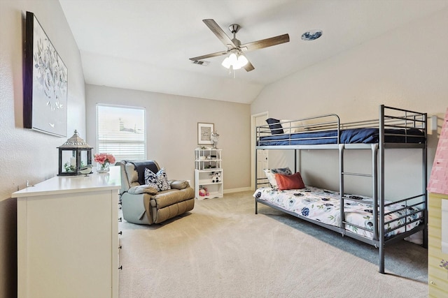 bedroom with a ceiling fan, light carpet, vaulted ceiling, and baseboards