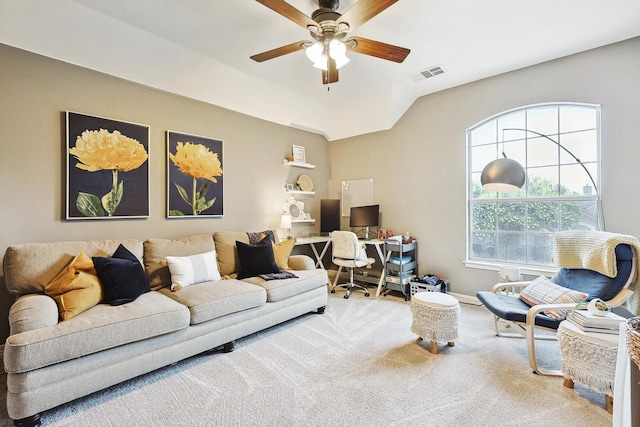 carpeted living area featuring vaulted ceiling, baseboards, visible vents, and a ceiling fan