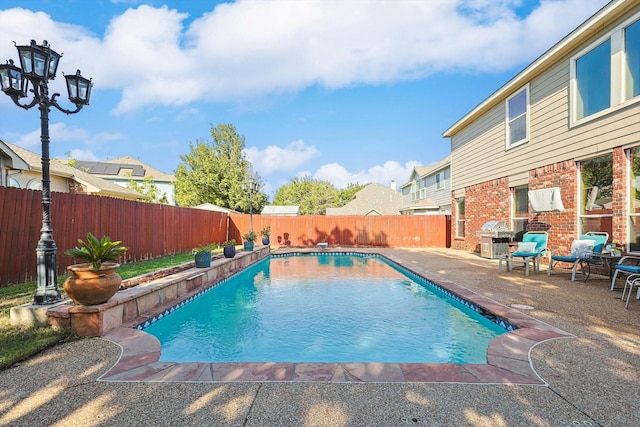 view of swimming pool featuring a patio area, a fenced backyard, and a fenced in pool