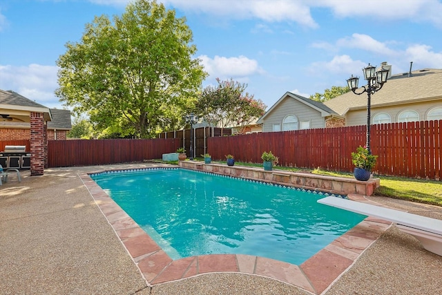 view of swimming pool with a patio, a fenced backyard, a diving board, grilling area, and a fenced in pool