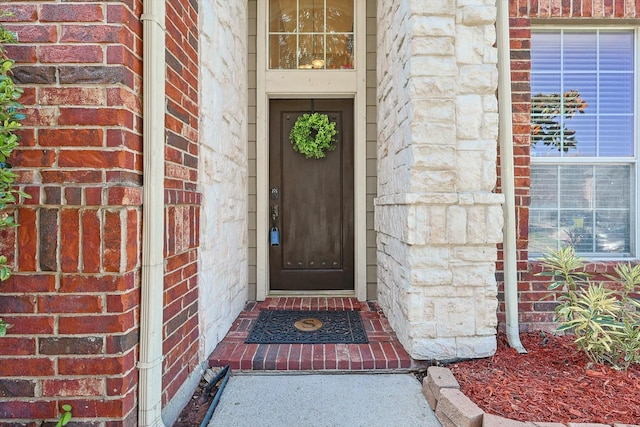 property entrance with brick siding