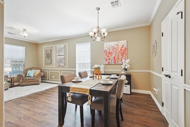 dining space with ornamental molding, dark wood finished floors, and visible vents