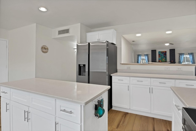 kitchen with recessed lighting, visible vents, white cabinetry, light countertops, and light wood-type flooring