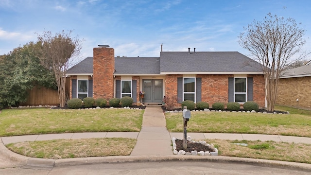 ranch-style home featuring brick siding, a shingled roof, fence, a chimney, and a front yard