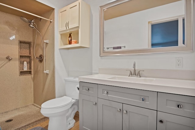 full bath featuring a stall shower, vanity, and toilet