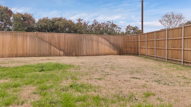 view of yard with a fenced backyard