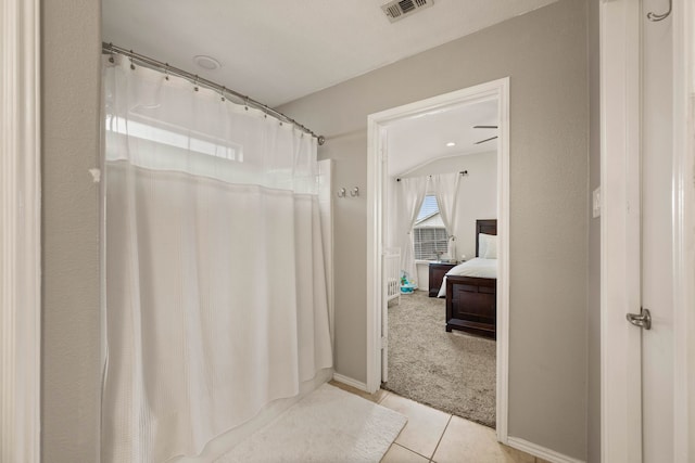 ensuite bathroom with tile patterned flooring, visible vents, connected bathroom, and baseboards