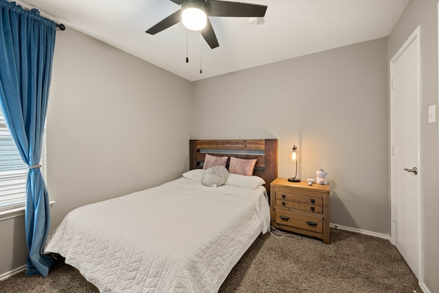 bedroom featuring ceiling fan, dark carpet, and baseboards