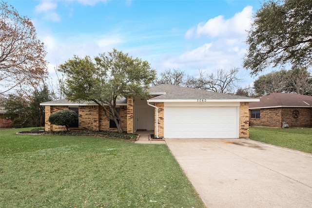 view of front facade featuring an attached garage, concrete driveway, brick siding, and a front yard