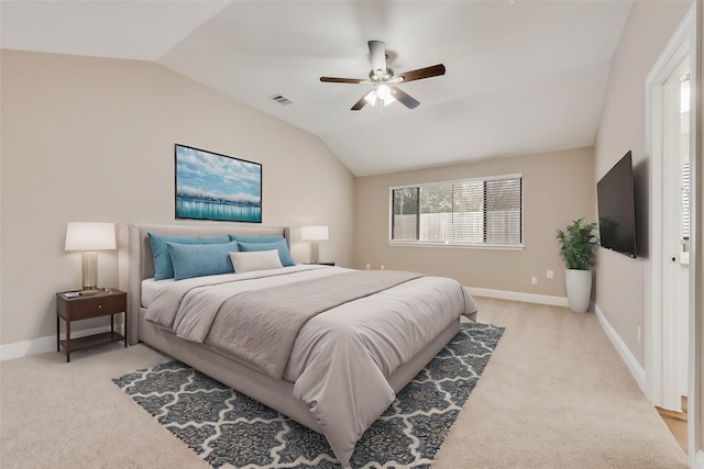 bedroom with lofted ceiling, light colored carpet, visible vents, and baseboards