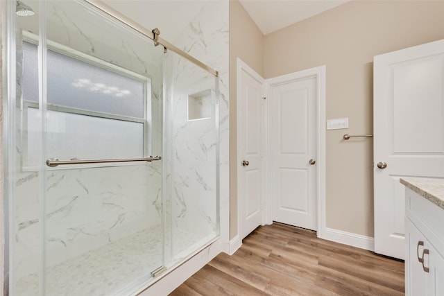 5040 Hollow Ridge Rd, Dallas, TX 75227 - bathroom with baseboards, wood finished floors, a marble finish shower, and vanity