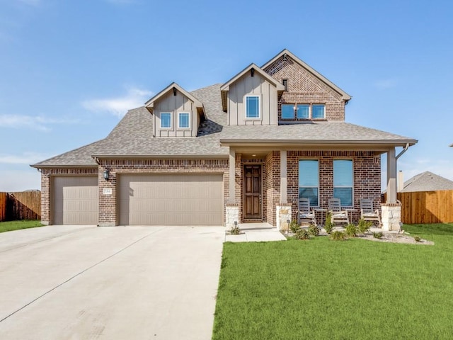 craftsman inspired home with concrete driveway, board and batten siding, fence, a garage, and a front lawn