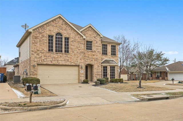 view of front of house featuring a garage, concrete driveway, cooling unit, and brick siding