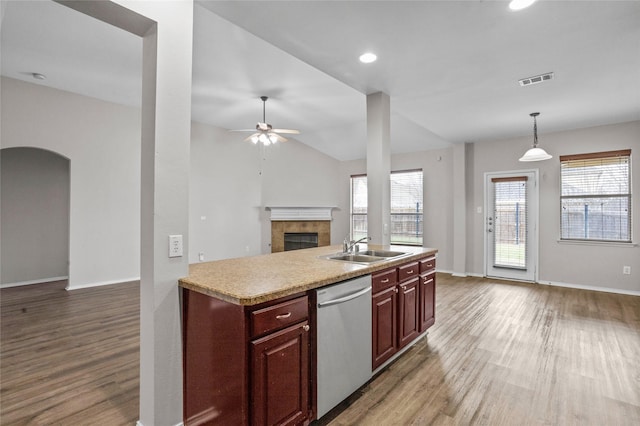 kitchen featuring dishwasher, open floor plan, decorative light fixtures, light countertops, and a sink