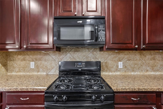 kitchen with black appliances, dark brown cabinets, backsplash, and light stone countertops