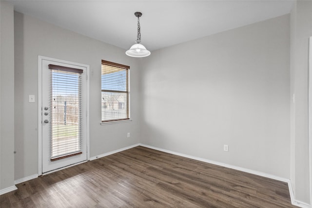 unfurnished room featuring dark wood finished floors and baseboards