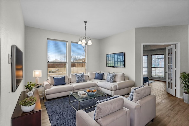 living area featuring a chandelier and wood finished floors