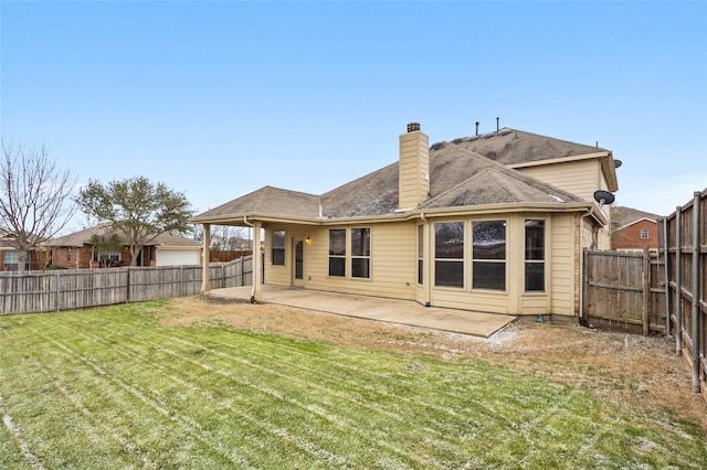 back of property featuring a patio area, a fenced backyard, a lawn, and a chimney