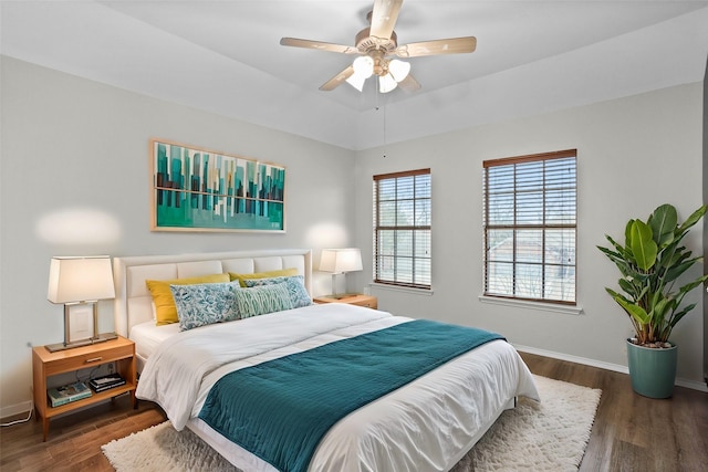 bedroom featuring dark wood-style floors, ceiling fan, and baseboards