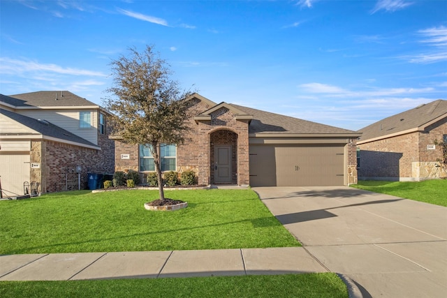 view of front of house featuring brick siding, roof with shingles, an attached garage, driveway, and a front lawn