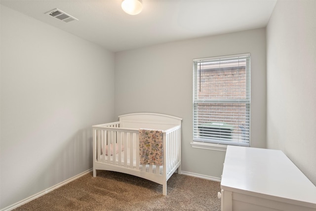 unfurnished bedroom with carpet flooring, visible vents, and baseboards