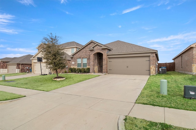 traditional home with a garage, concrete driveway, central air condition unit, a front lawn, and brick siding