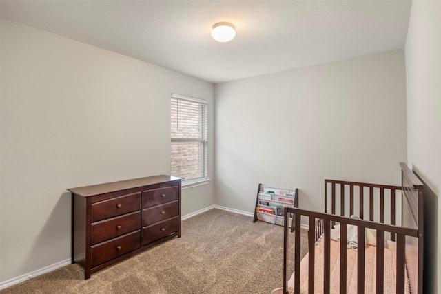 bedroom with light carpet and baseboards