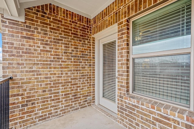 entrance to property featuring brick siding