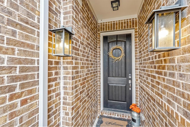 property entrance with brick siding