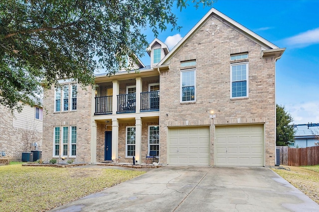 view of front of home featuring brick siding, concrete driveway, a balcony, a garage, and a front lawn