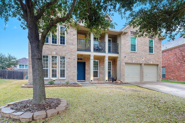 view of front of house featuring brick siding, concrete driveway, a balcony, an attached garage, and a front yard